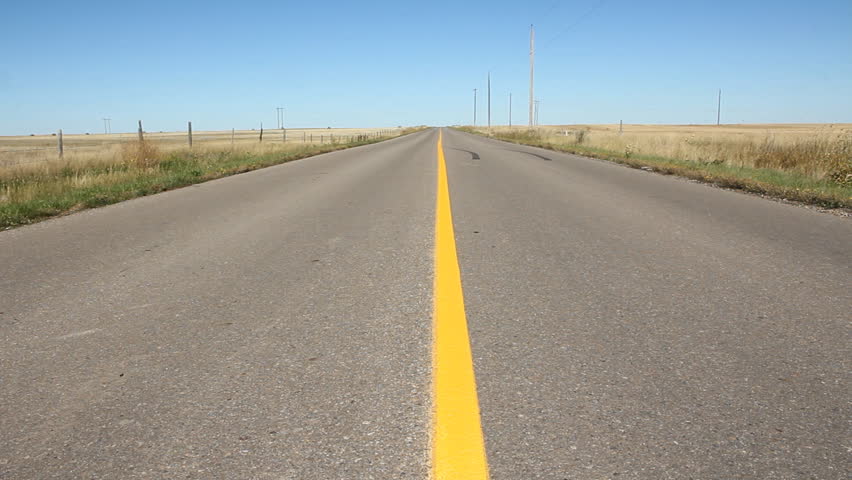 middle-of-the-road-low-angle-center-view-of-road-with-yellow-line