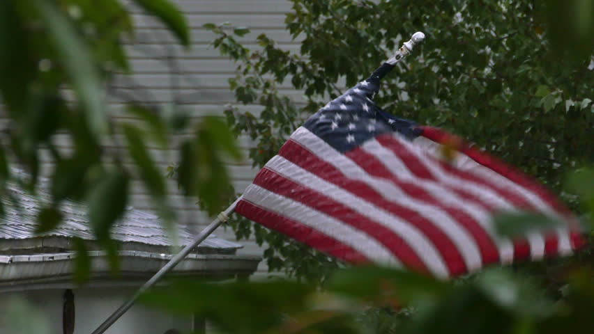 american-flag-blowing-in-rain-storm-stock-footage-video-12605786