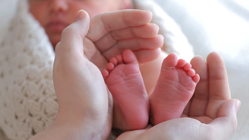 baby-feet-in-mother-hands-tiny-newborn-baby-s-feet-on-female-heart