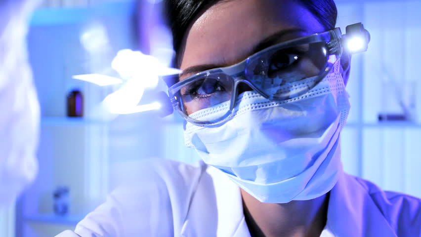 Female Laboratory Technician In Protective Mask And