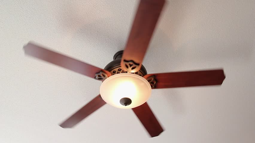 A Ceiling Fan Spins On High Setting With Light Stock Footage Video A Ceiling Fan Turns Slowly With Light Hd Stock Video Clip