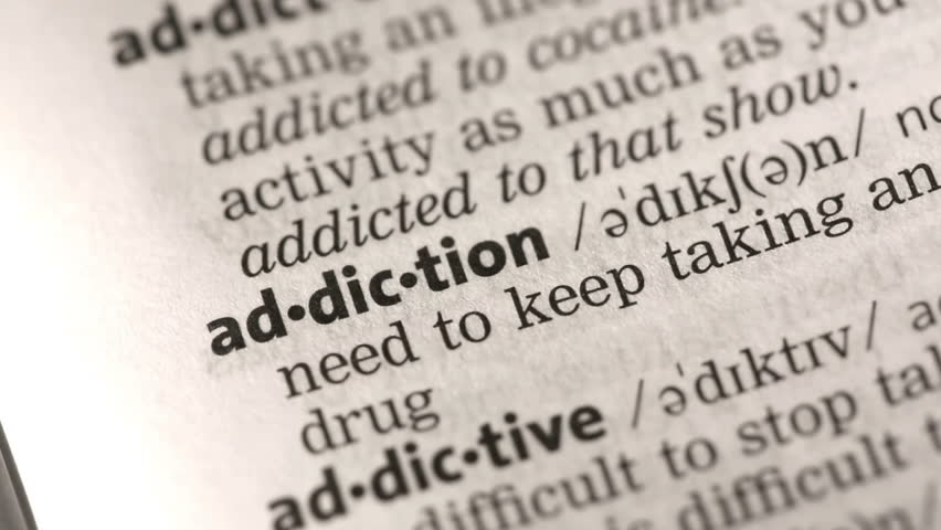 definition-of-addiction-highlighted-in-the-dictionary-stock-footage