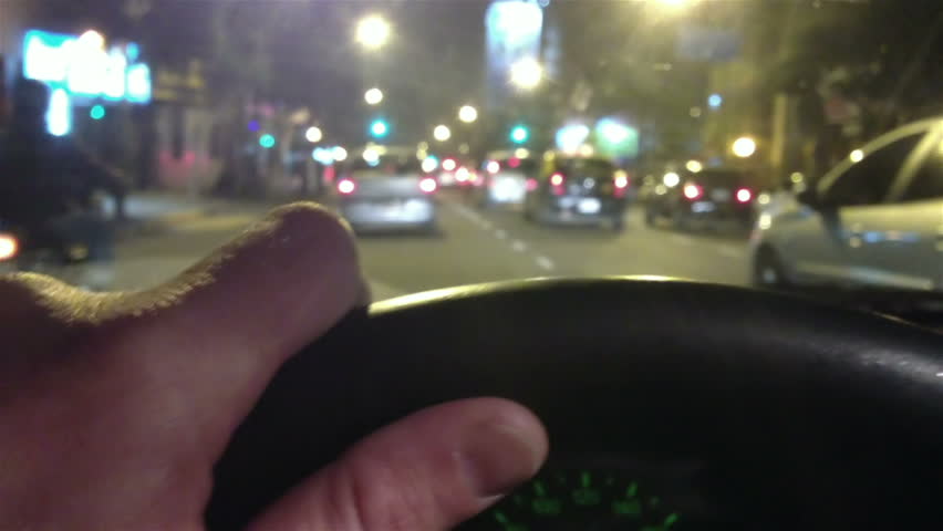 Driving At Night On The City Hand On Steering Wheel Close Up POV