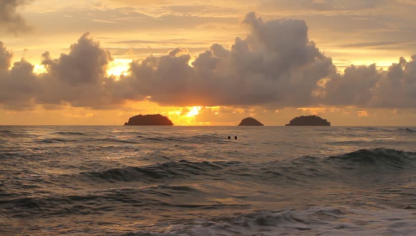 waves-gently-wash-up-onto-the-beach-then-recede-as-the-sun-starts-to