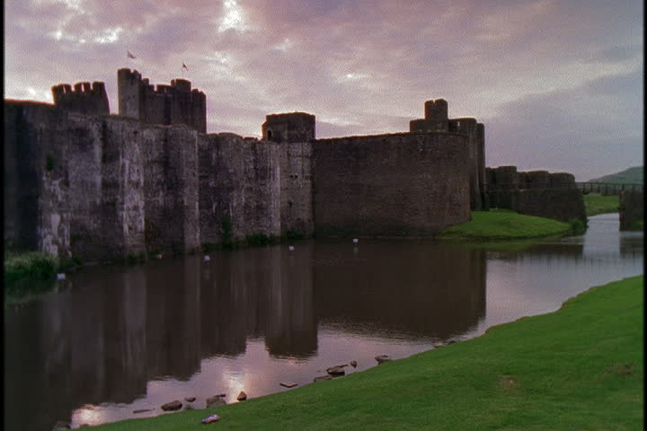 Caerphilly Castle With Reflection In Moat In Caerphilly, South Wales 