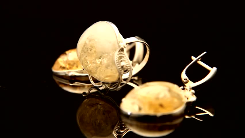 Expensive silver diamond ring turning on themselves against a black ... Expensive silver diamond ring turning on themselves against a black ...