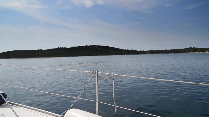 Yacht sailing in Dalmatia, Croatia, during summer and calm sea with cloudy sky - HD stock footage clip