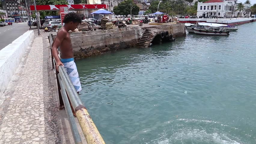 SALVADOR, BRAZIL - CIRCA NOVEMBER 2014: Brazilian Young Guy Jumping into the Sea - HD stock footage clip