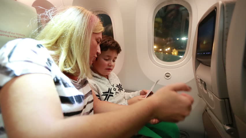 kid with mom in plane