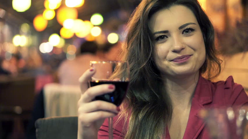 Portrait Of Beautiful Happy Woman Drinking Wine At Night In Cafe Bar