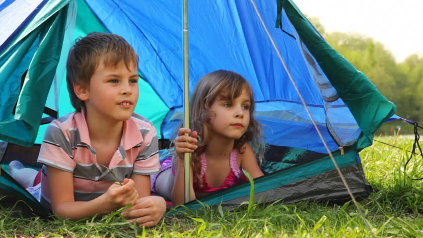 Boy And Little Girl With Glass Sit In Tent At Woods Hot Summer, He ...