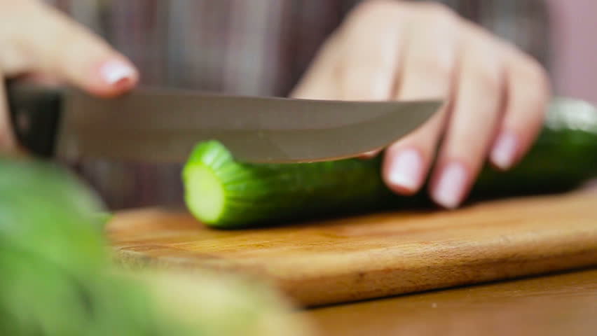 Women Hands With Knife Cutting Cucumber On Board In Kitchen Stock ...