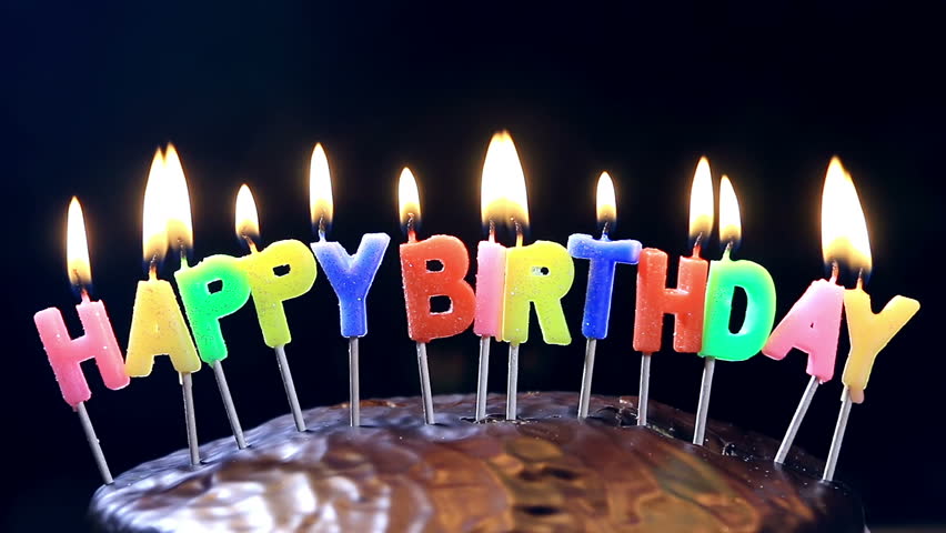 Colourful Happy Birthday Candles Being Blown Out On Black Background In ...