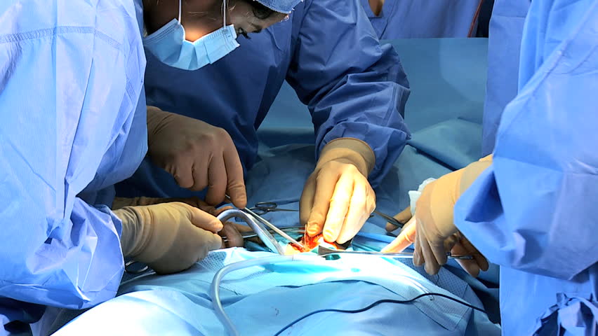 Close Up Male Female Surgical Team In Protective Clothing Performing ...