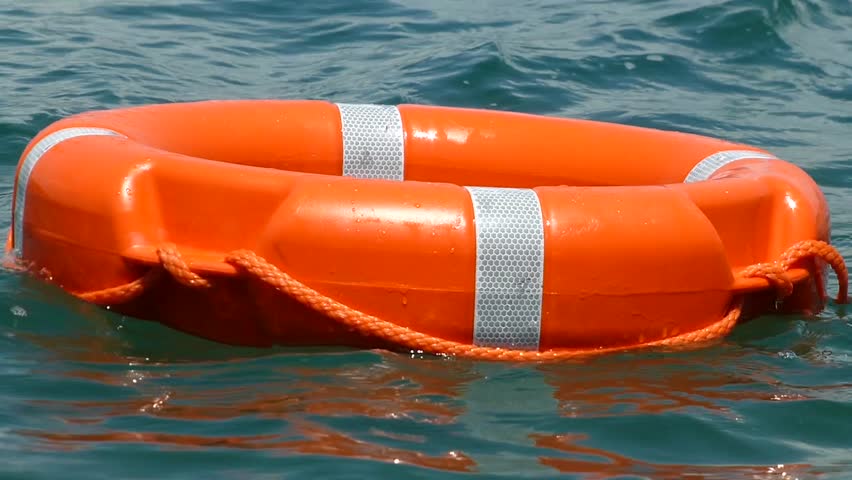 A White Rescue Buoy Being Thrown Into The Water,floating On The Surface ...