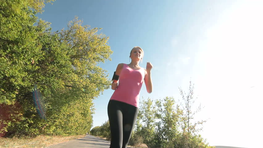 Teen Blonde Girl Running Along Country Road Looking At The Camera ...