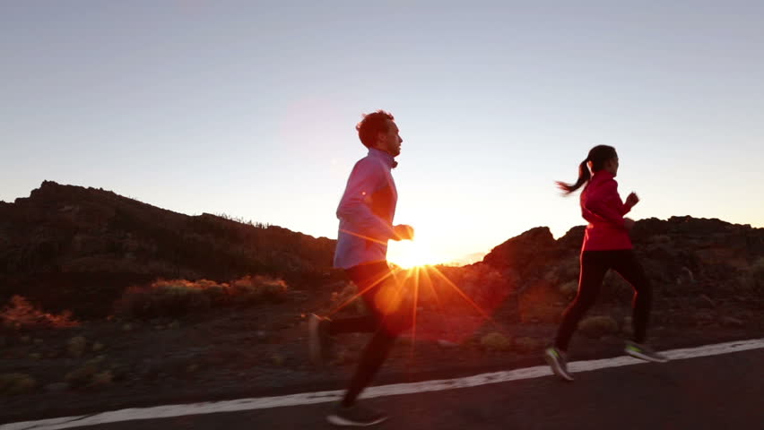 Running Sport Athletes Woman And Man Jogging At Night Sunset. Runners ...