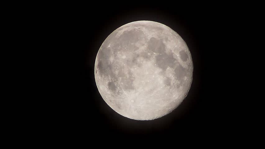 Dark Clouds Slowly Moving Through The Full Moon, Shining On A Black Sky ...