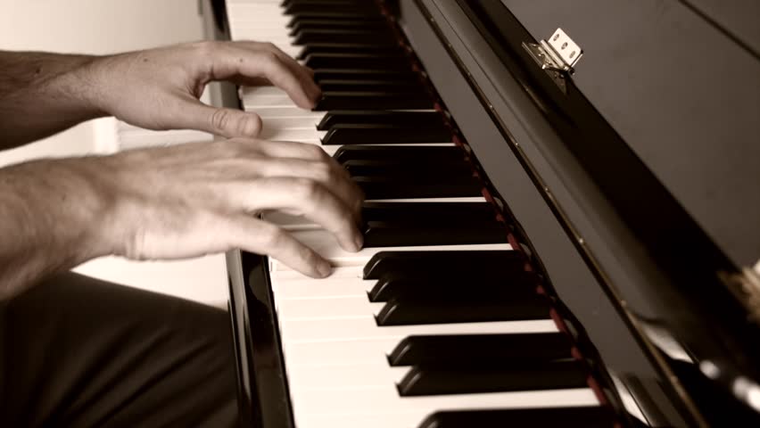 A Beautiful Shot Of A Man Playing A Song On A Black And White Piano ...