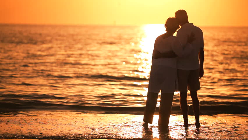 Contented Senior Couple Enjoying A Romantic Sunset Evening Together On ...